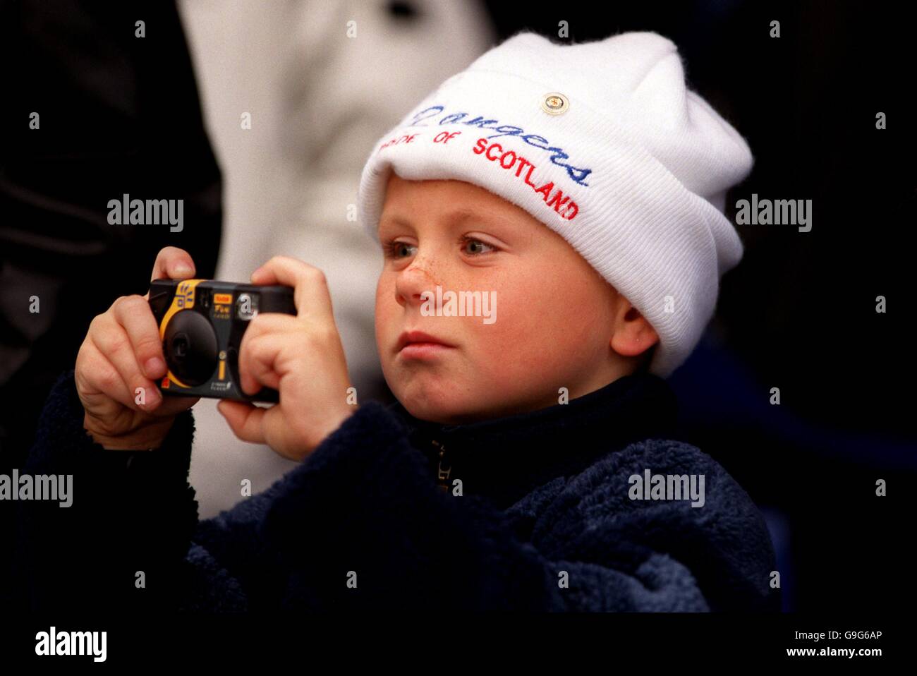 Soccer - Bank Of Scotland Premier League - Rangers v Celtic. A young Rangers fan takes some photos of his heroes Stock Photo