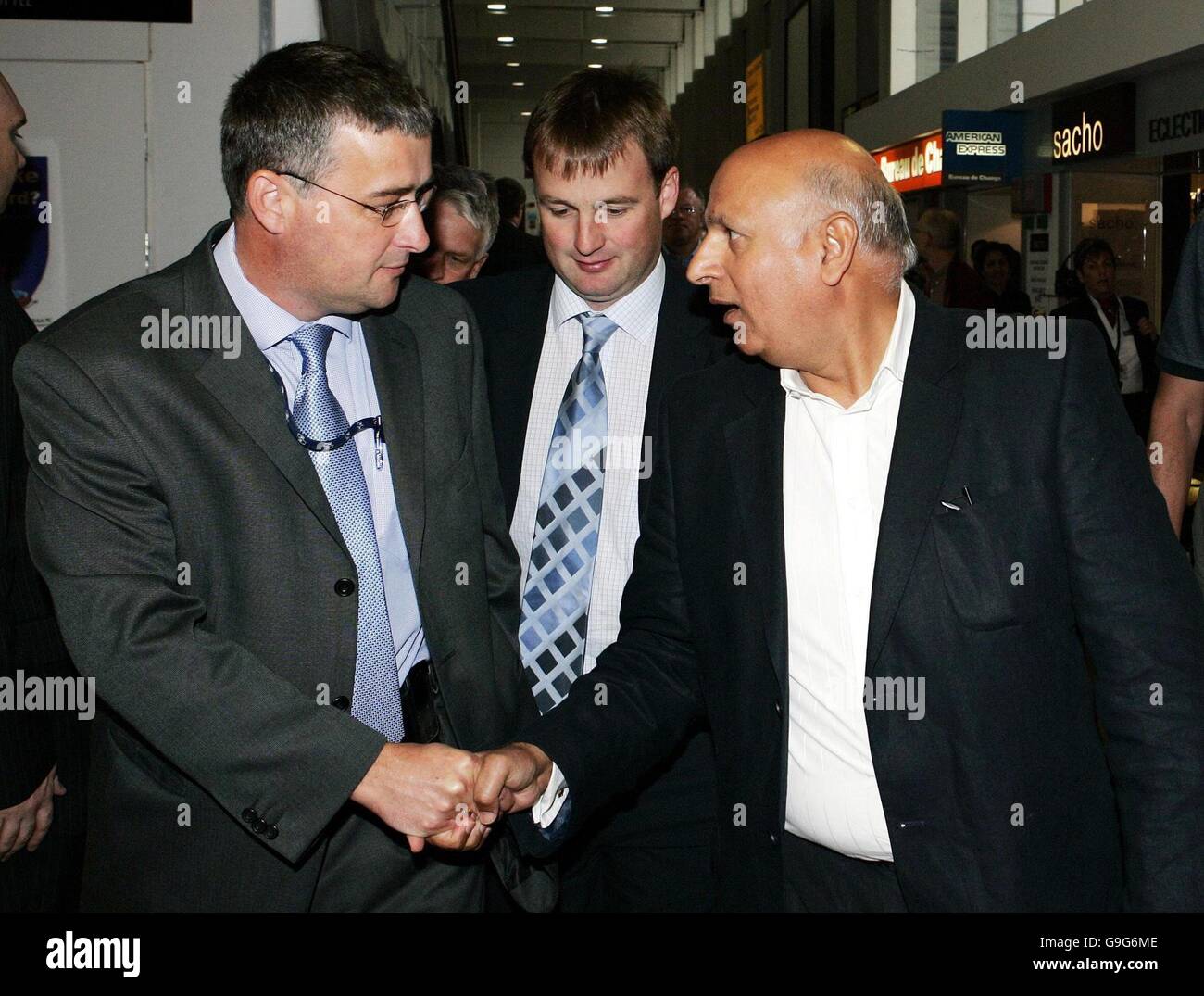 Labour MP Mohammed Sarwar (right) shakes hands with Detective Inspector Gordon Greenlees while Western Isles Labour MSP Alasdair Morrison looks on at arrival at Glasgow Airport, where they are to meet the mother of missing 12-year-old Molly Campbell before Mr Sarwar flies to Pakistan, where Molly is understood to have been taken by her sister and father. Stock Photo