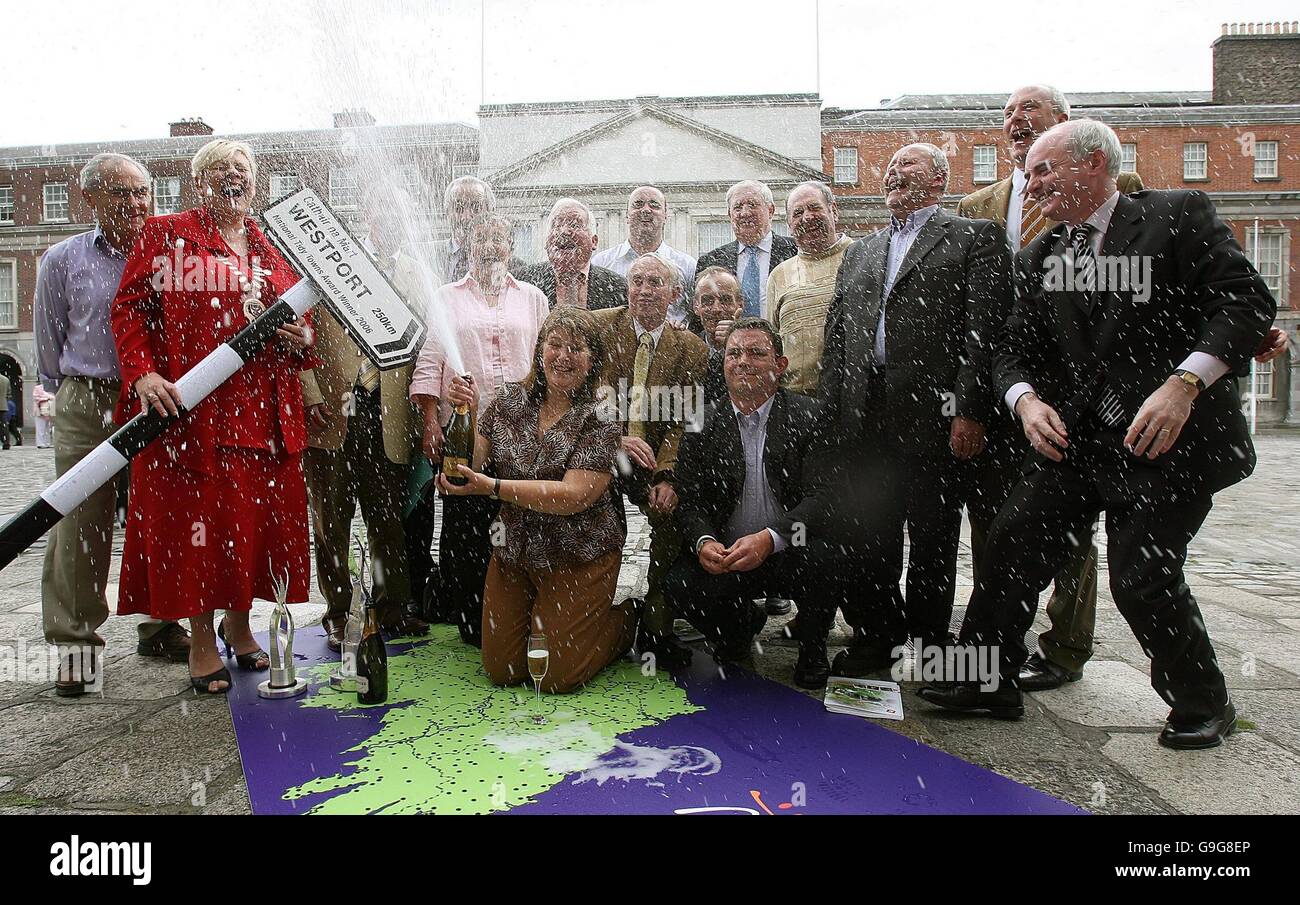 Elsie Higgins, chair of Westport Tidy Towns (with champagne, centre), celebrates after the Co