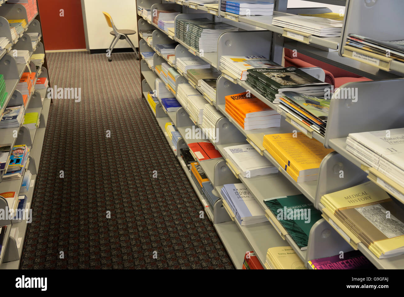 Journals, periodicals on shelves, at a university library Stock Photo