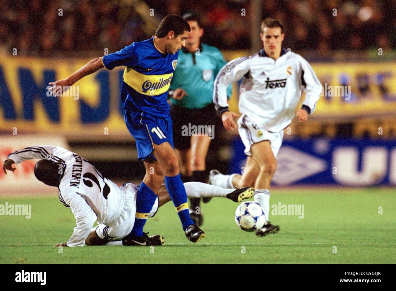 Real Madrid's Claude Makelele (l) is knocked to the floor as Boca Juniors' Juan Roman Riquelme (r) wins possesion Stock Photo