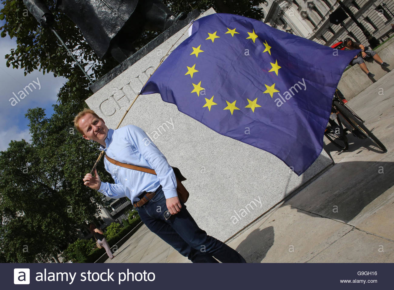 An EU supporter with the EU flag at Westminster the morning after the Brexit result was announced. Stock Photo