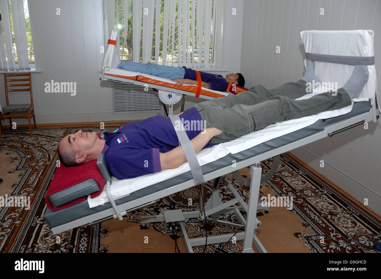 International Space Station Expedition 48 Russian cosmonaut Anatoly Ivanishin, foreground, and Japanese astronaut Takuya Onishi during the tilt table test of their vestibular system at the Cosmonaut Hotel June 30, 2016 in the Baikonur Cosmodrome in Kazakhstan. Anatoly Ivanishin, Takuya Onishi and Kate Rubins are scheduled to launch on four-month mission July 7th. Stock Photo