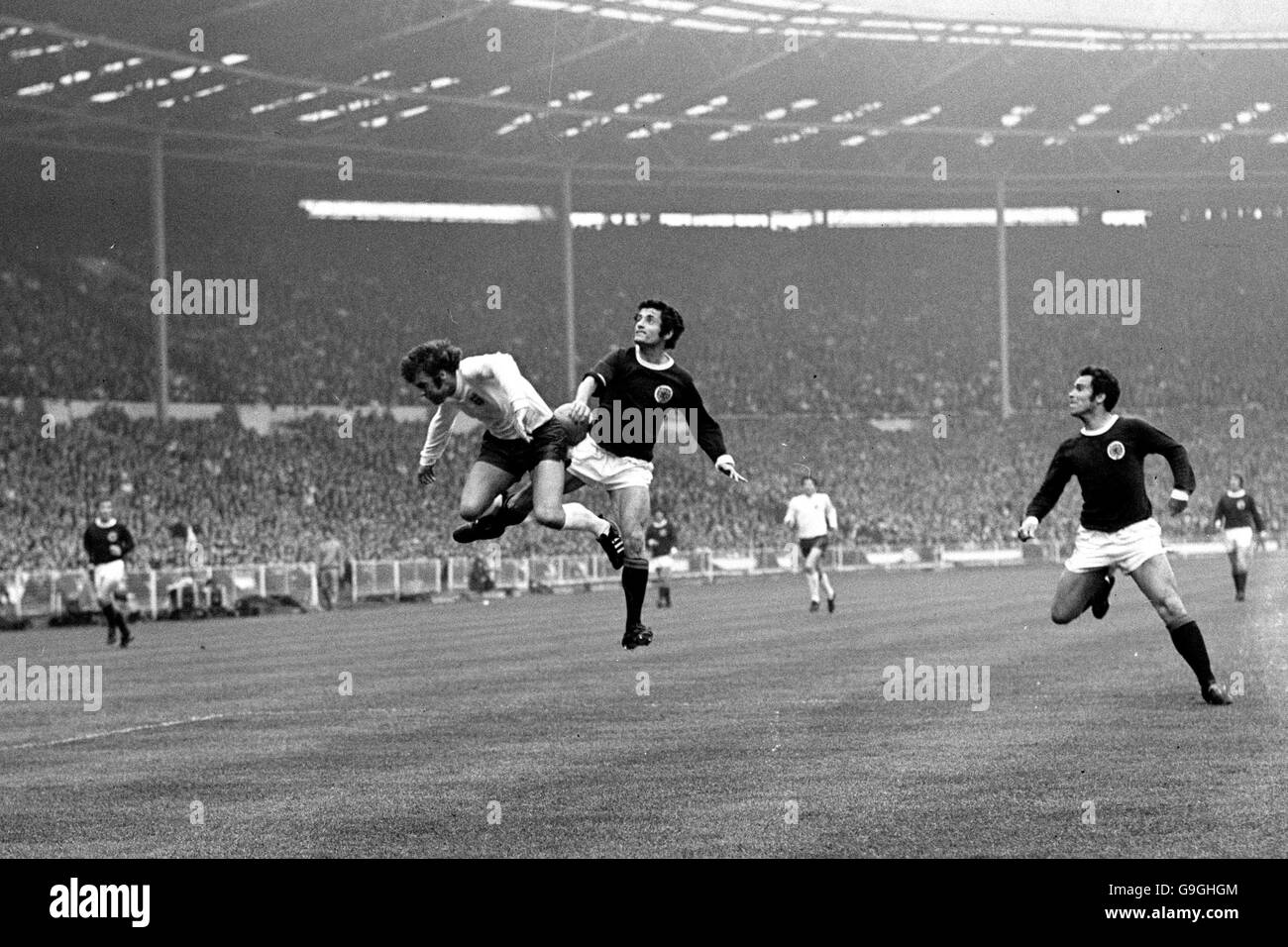 Soccer - Home International Championship - England v Scotland. Scotland's Frank McLintock (c) outjumps England's Geoff Hurst (l) as Bobby Moncur covers Stock Photo