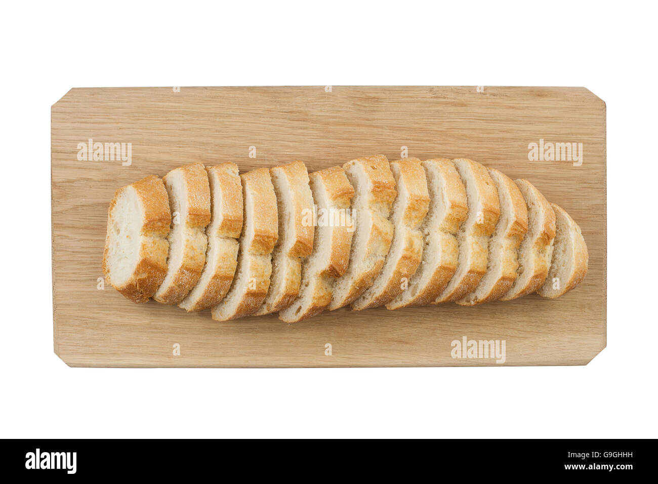 White ciabatta bread being cut in slices on wooden board isolated on white background Stock Photo