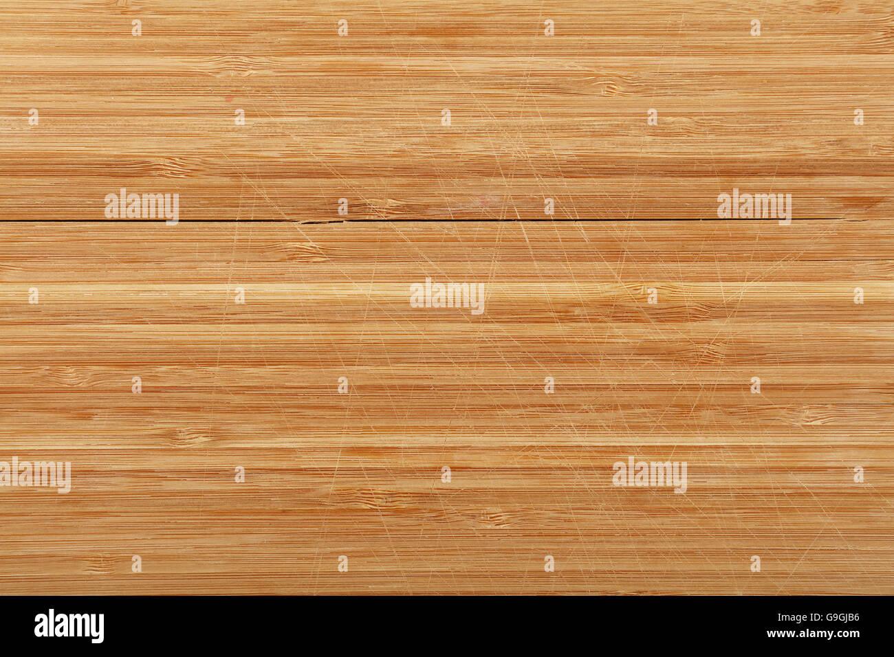 Metal kitchen thongs on wooden board Stock Photo - Alamy