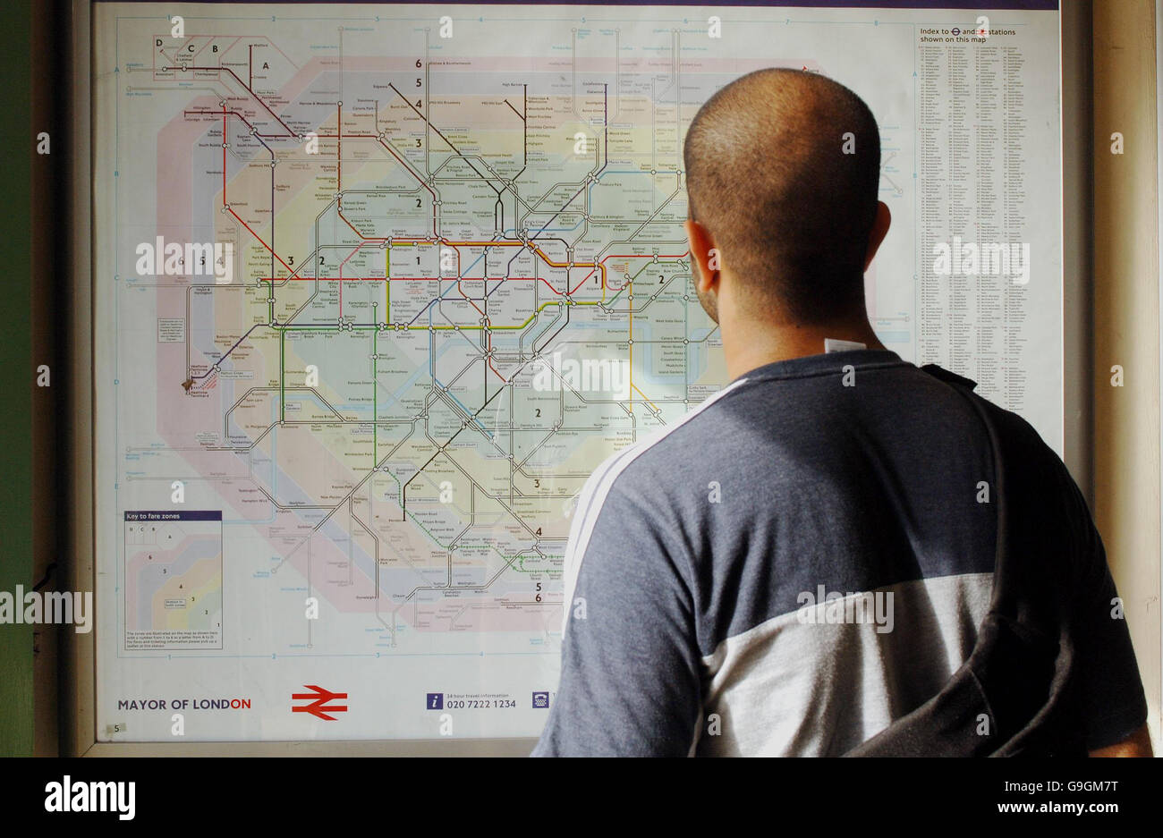 A Passenger looks at the Underground map at the Mile End Station in East London. Stock Photo
