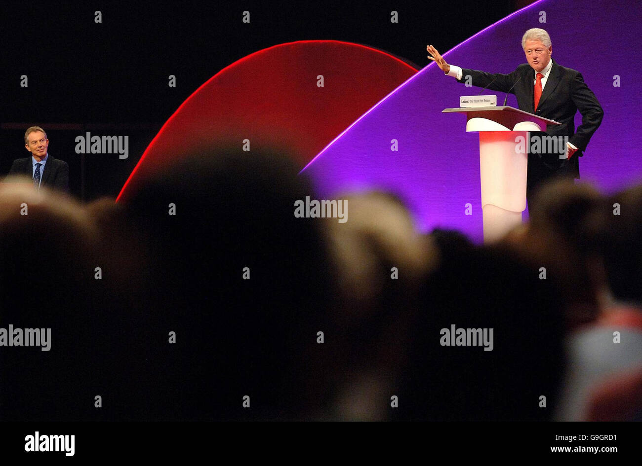Former US President Bill Clinton speaks at the Labour Party conference while Prime Minister Tony Blair listens. Stock Photo