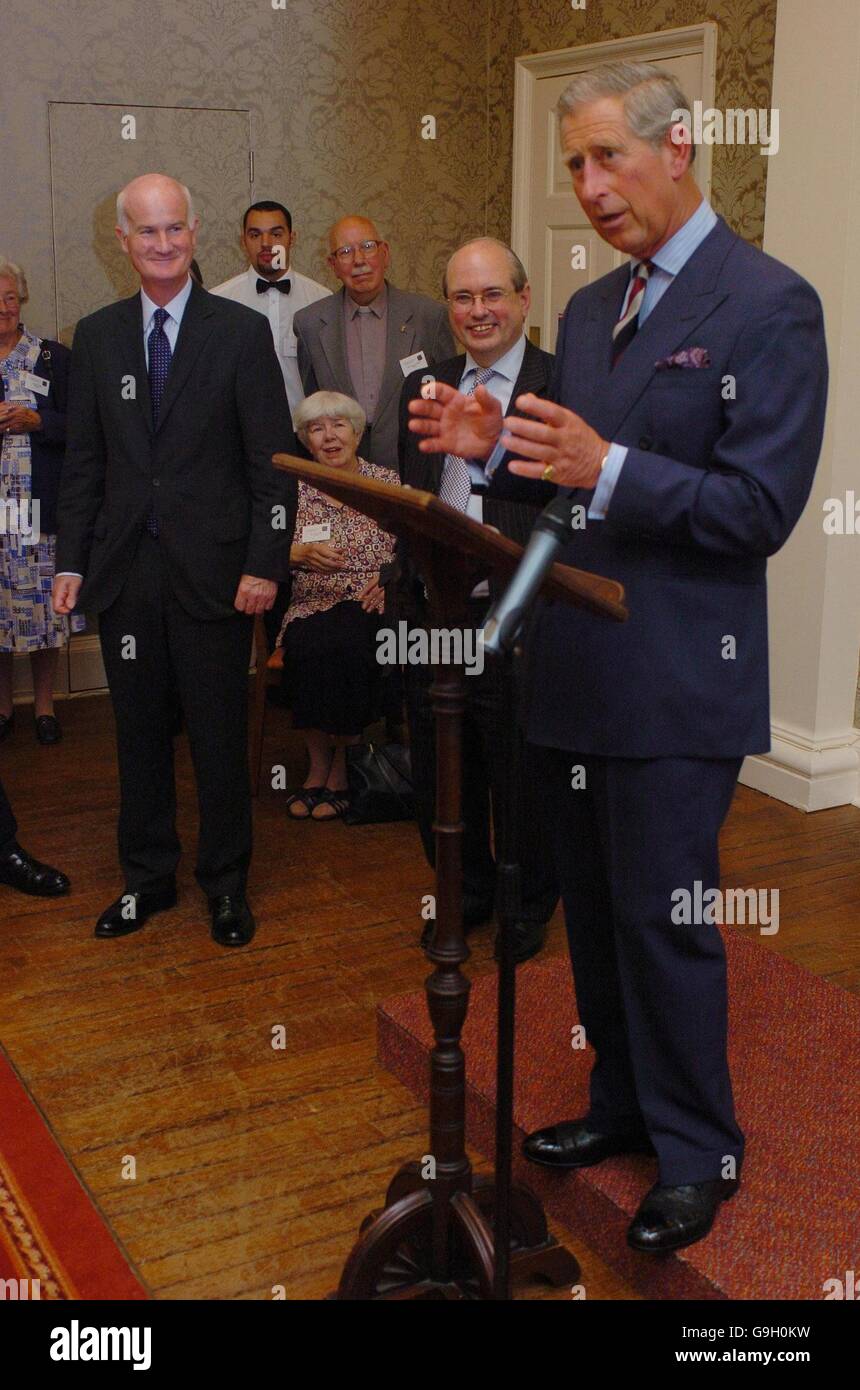 The Prince of Wales gives the inaugural address at The Prayer Book Society's Annual Conference during an evening reception at Lady Margaret Hall in Oxford, Oxfordshire, as the Society's Chairman, Roger Evans (centre-right) and Sir Michael Peat (left) look on. Stock Photo