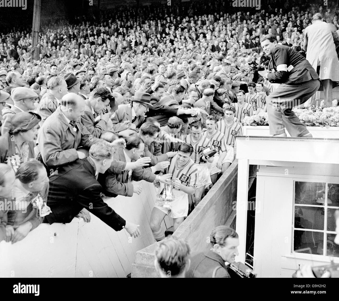 Aston Villa captain Johnny Dixon leads his team down the steps after collecting the FA Cup. Stock Photo