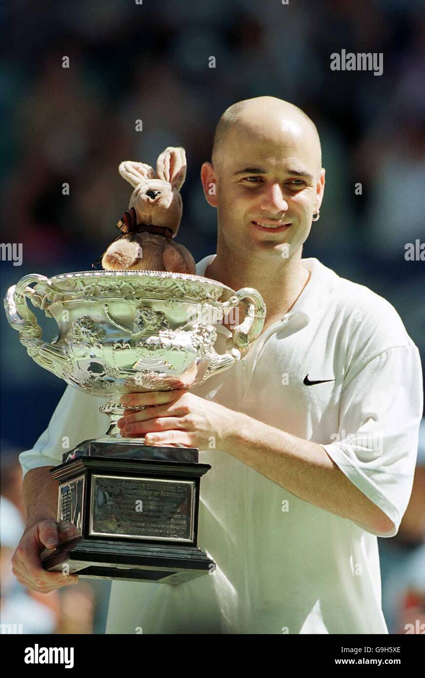 Andre Agassi holds the Australian Open Mens Final Trophy aloft after