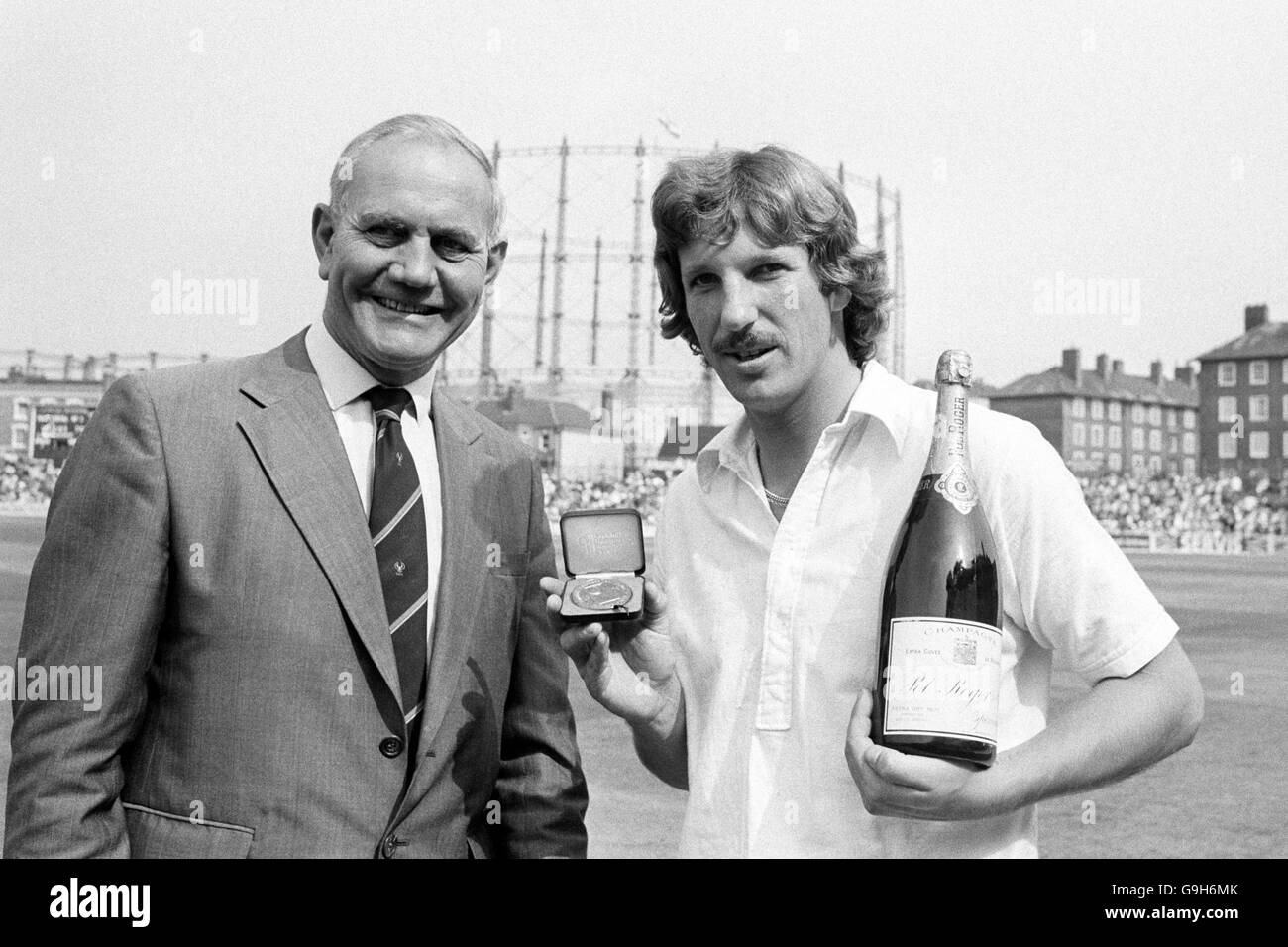 England's Ian Botham (r), who completed the fastest test double of 1000 runs and 100 wickets on the first day's play, is presented with a special Cornhill medallion and a magnum of champagne by Alec Bedser (l), chairman of the England test selectors Stock Photo