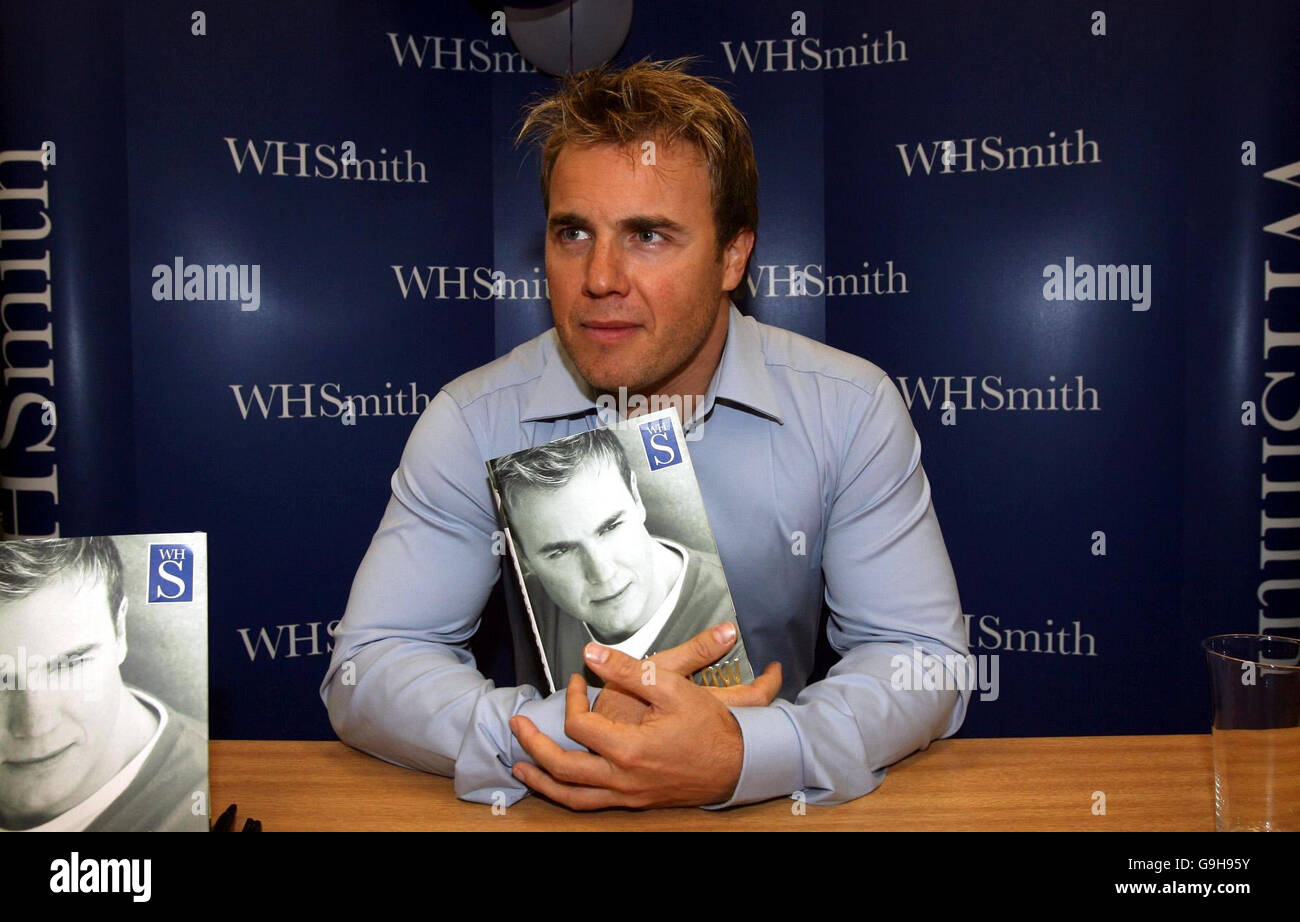 Gary Barlow of Take That signs copies of his autobiography, My Take, at W H Smith in the Trafford Centre in Manchester. The fans who arrived to meet the singer included Ben Maher aged 2 and his mother Cathy. Stock Photo