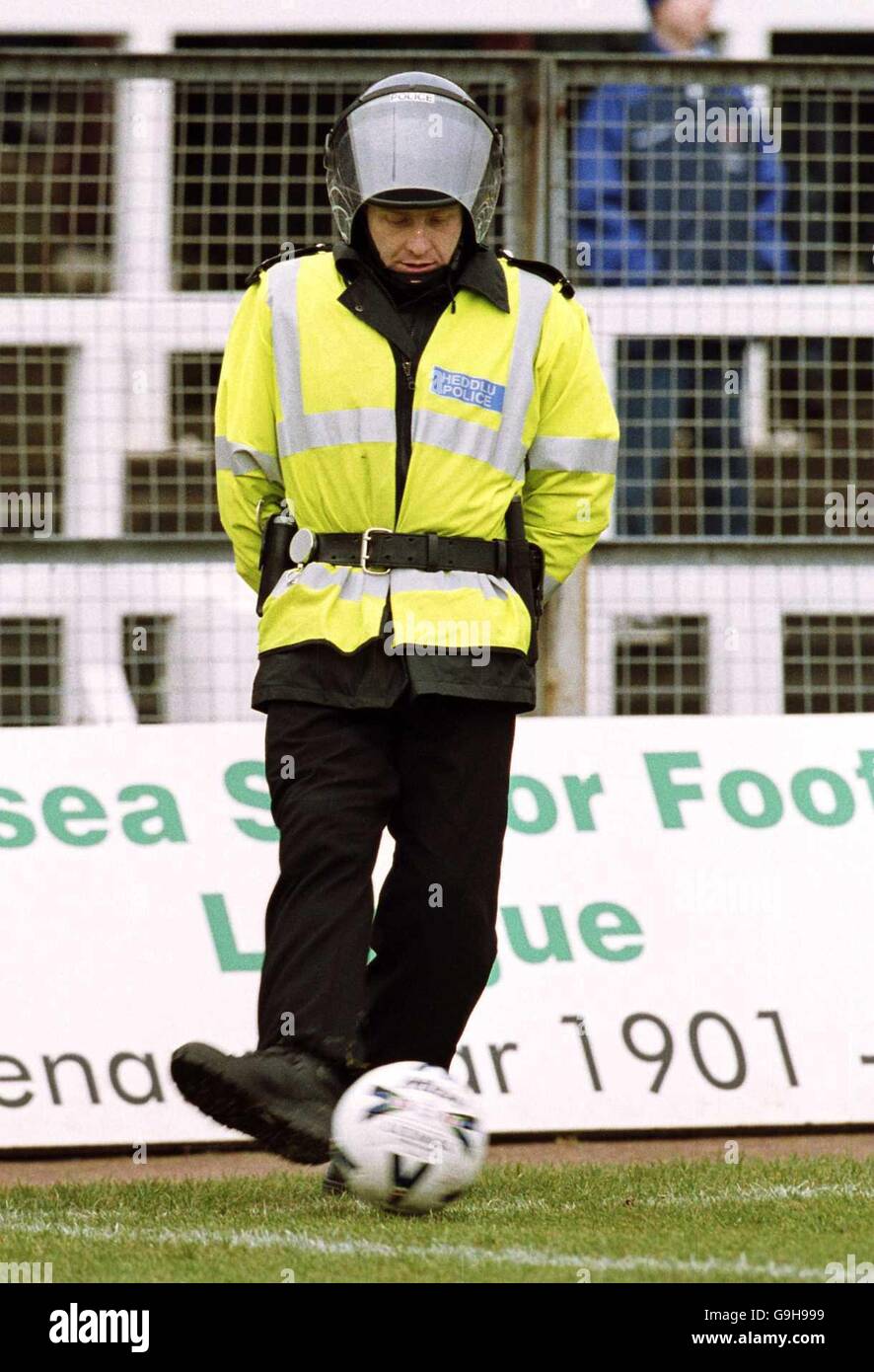 Soccer - Nationwide League Division Two - Swansea City v Millwall. A  policeman in a riot helmet grabs
