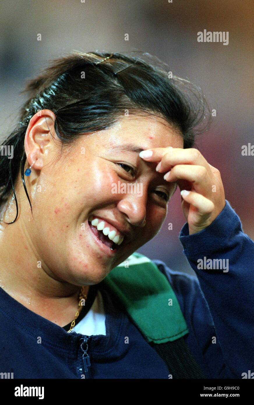 Thailand's Tamarine Tanasugarn has time to laugh during her match with Switzerland's Martina Hingis and Roger Federer Stock Photo