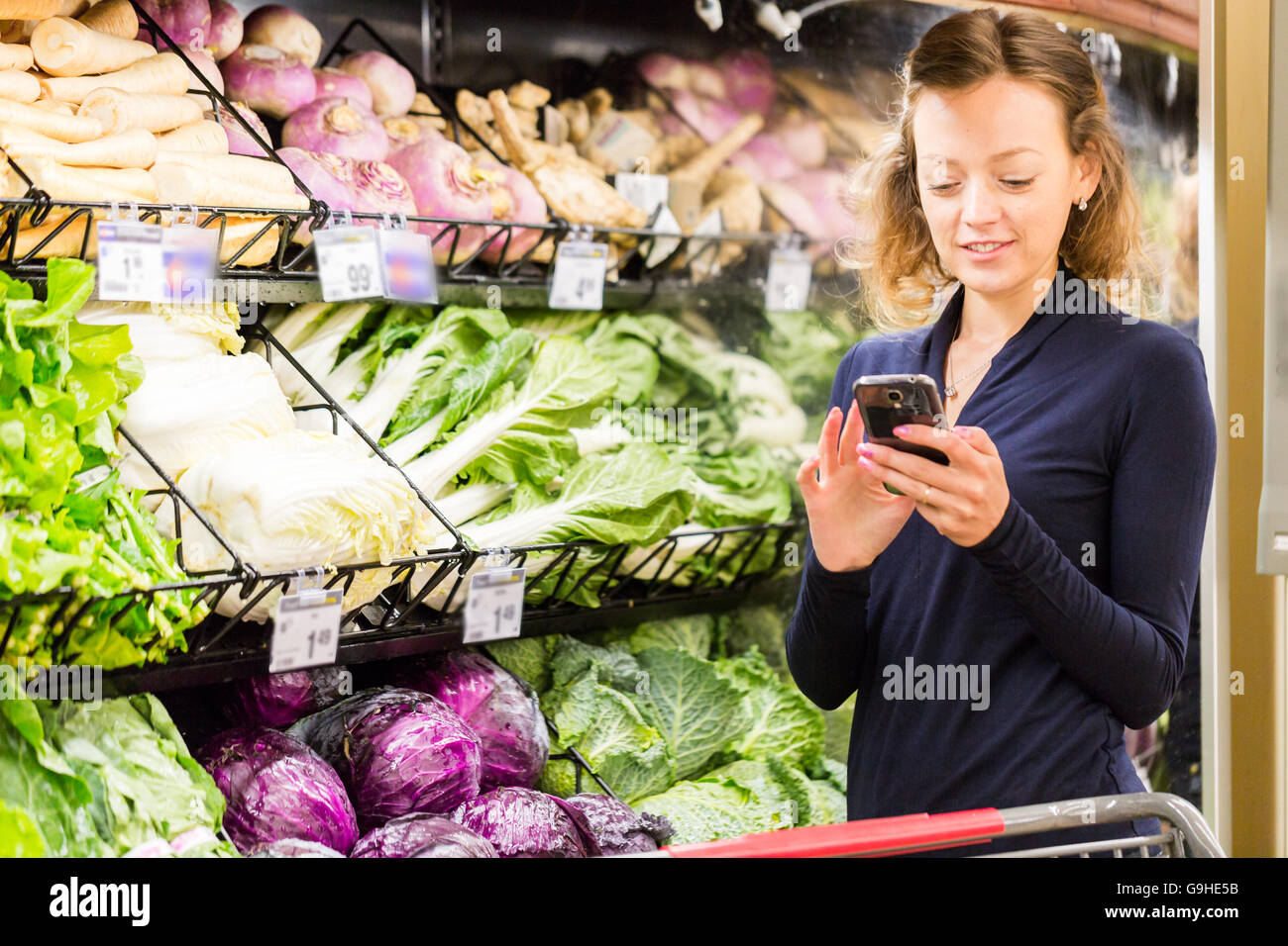 https://c8.alamy.com/comp/G9HE5B/young-woman-shopping-in-the-fresh-produce-section-at-the-grocery-store-G9HE5B.jpg