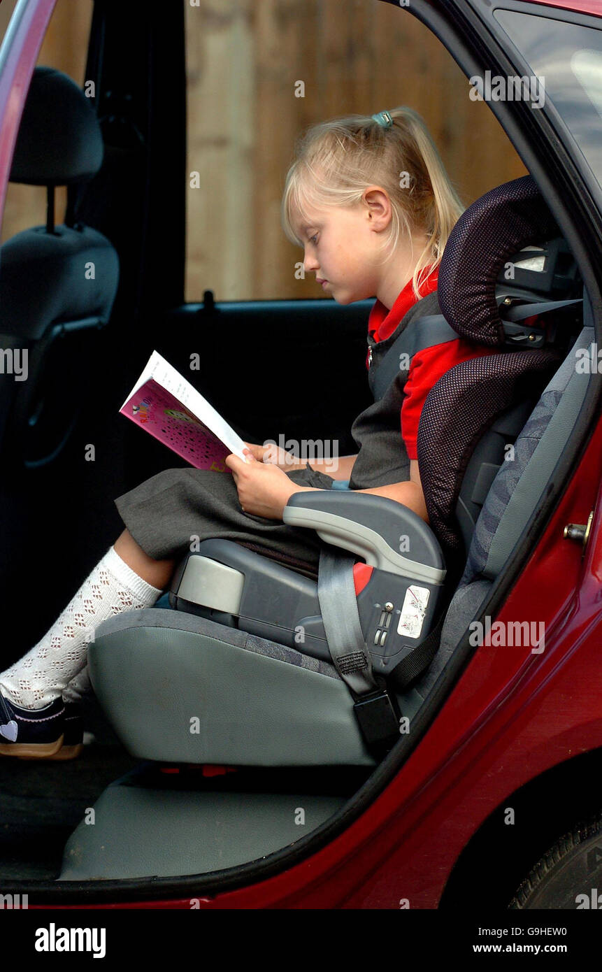 Picture posed by model of a seven year old girl using a car seat in
