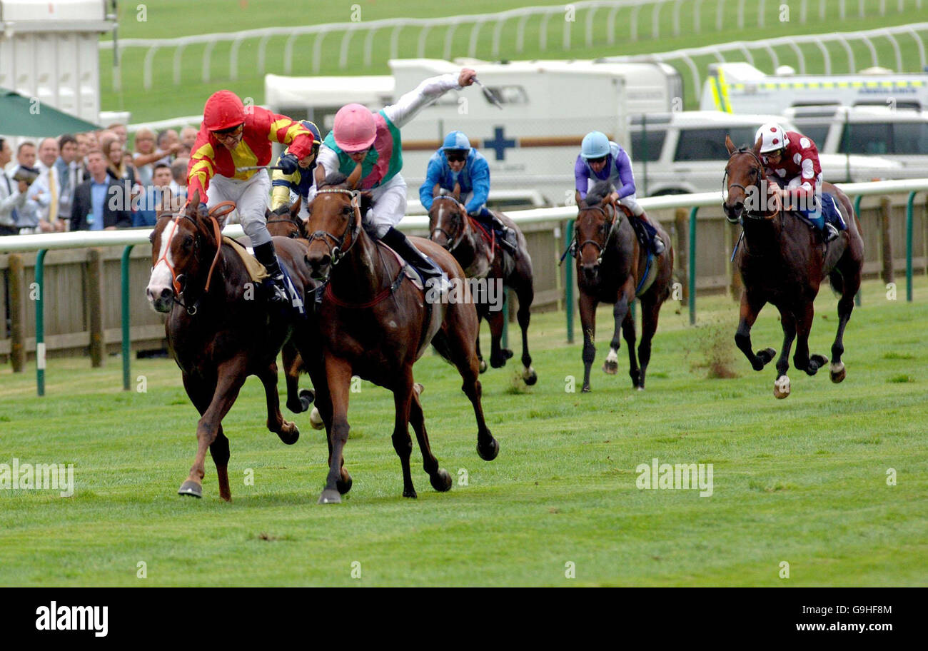 Novellara ridden by Richard Hughes (centre, pink cap) wins the Unicoin Homes Noel Murless Stakes at the Rowley Mile Racecourse in Newmarket, Suffolk. Stock Photo