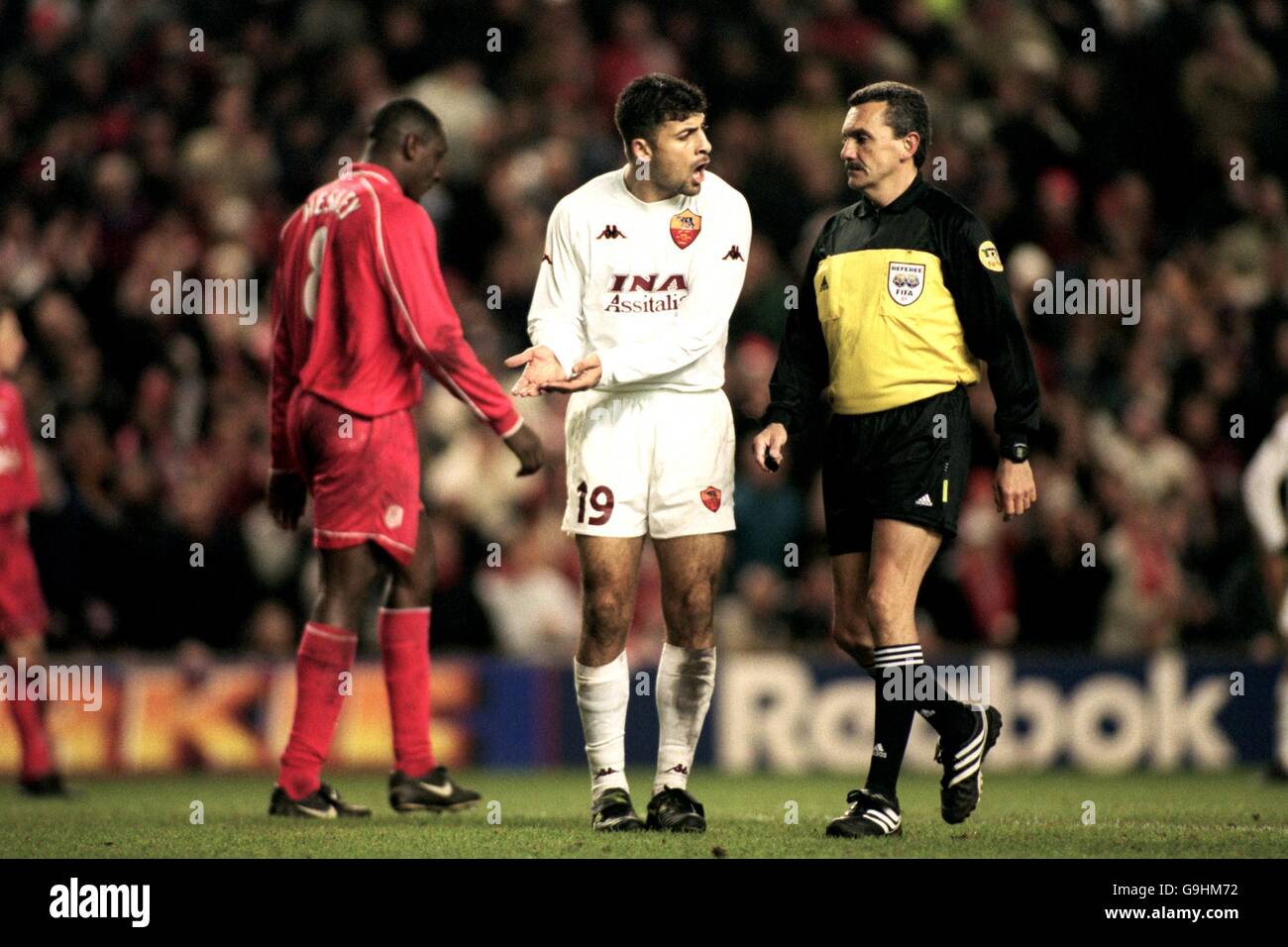 Soccer - UEFA Cup - Fourth Round Second Leg - Liverpool v AS Roma. AS Roma's Walter Samuel (c) protests to the referee Jose Maria Garcia Aranda (r) after he awarded Liverpool a penalty Stock Photo