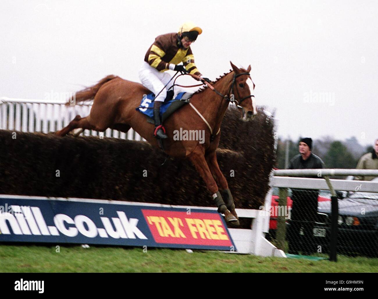 Irish Option ridden by Andrew Thornton jumps the last to win the Courage Best Novices Chase Stock Photo