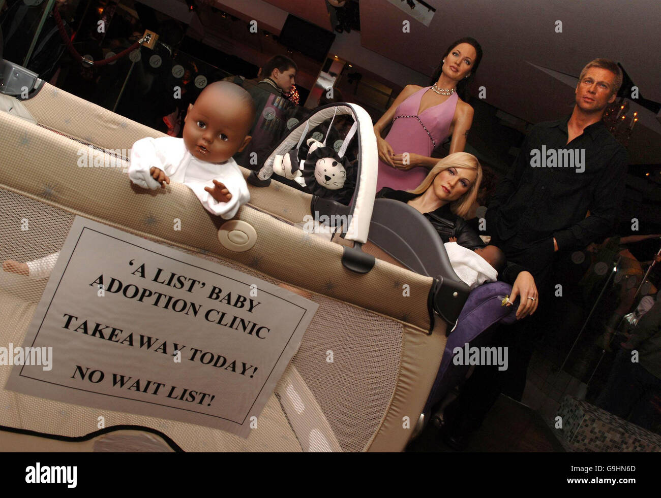 An exhibition themed around the celebrity baby adoption debate, featuring the Madonna, Brad Pitt & Angelina Jolie mannequins, at Madame Tussauds, central London. Stock Photo