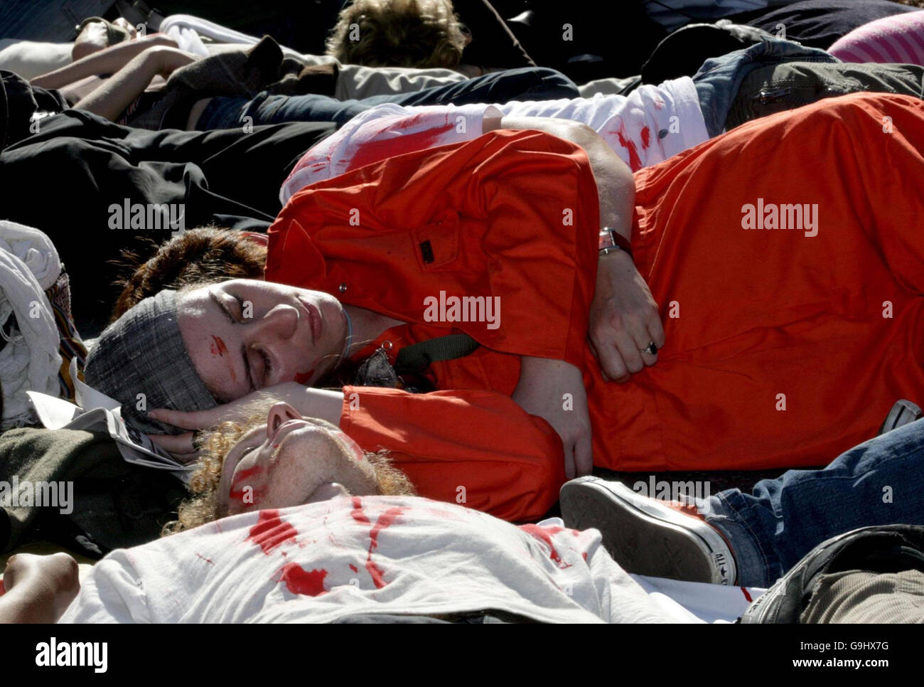 Marchers play dead during an anti-war protest march in Manchester. Stock Photo