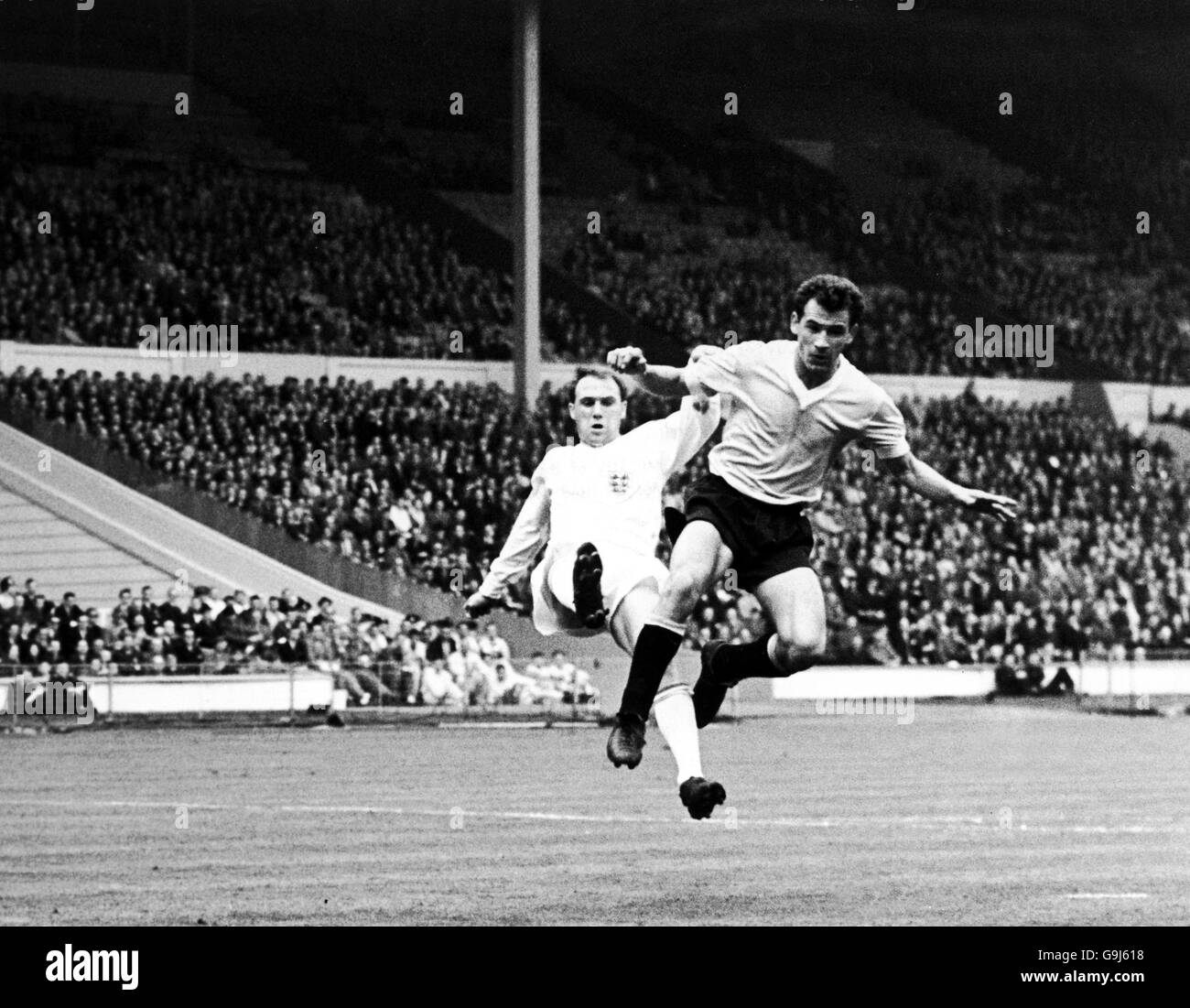 Soccer - Friendly - England v Uruguay. England's Ray Wilson (l) clears from Uruguay's N Flores (r) Stock Photo