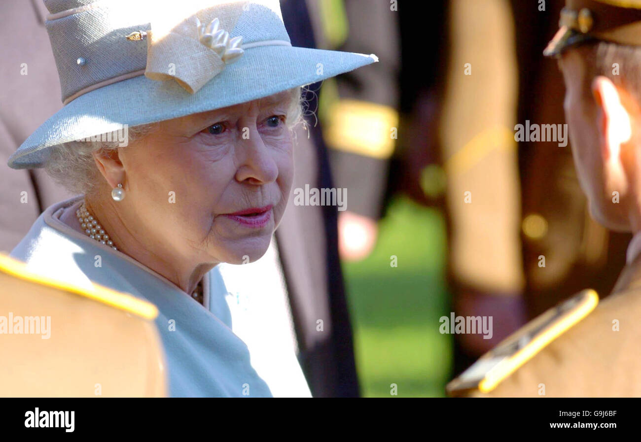 Britain's Queen Elizabeth II speaks to soldiers from the Lithuanian Army during a visit to the Anatakalnio Cemetery, Vilnius, Lithuania. Stock Photo