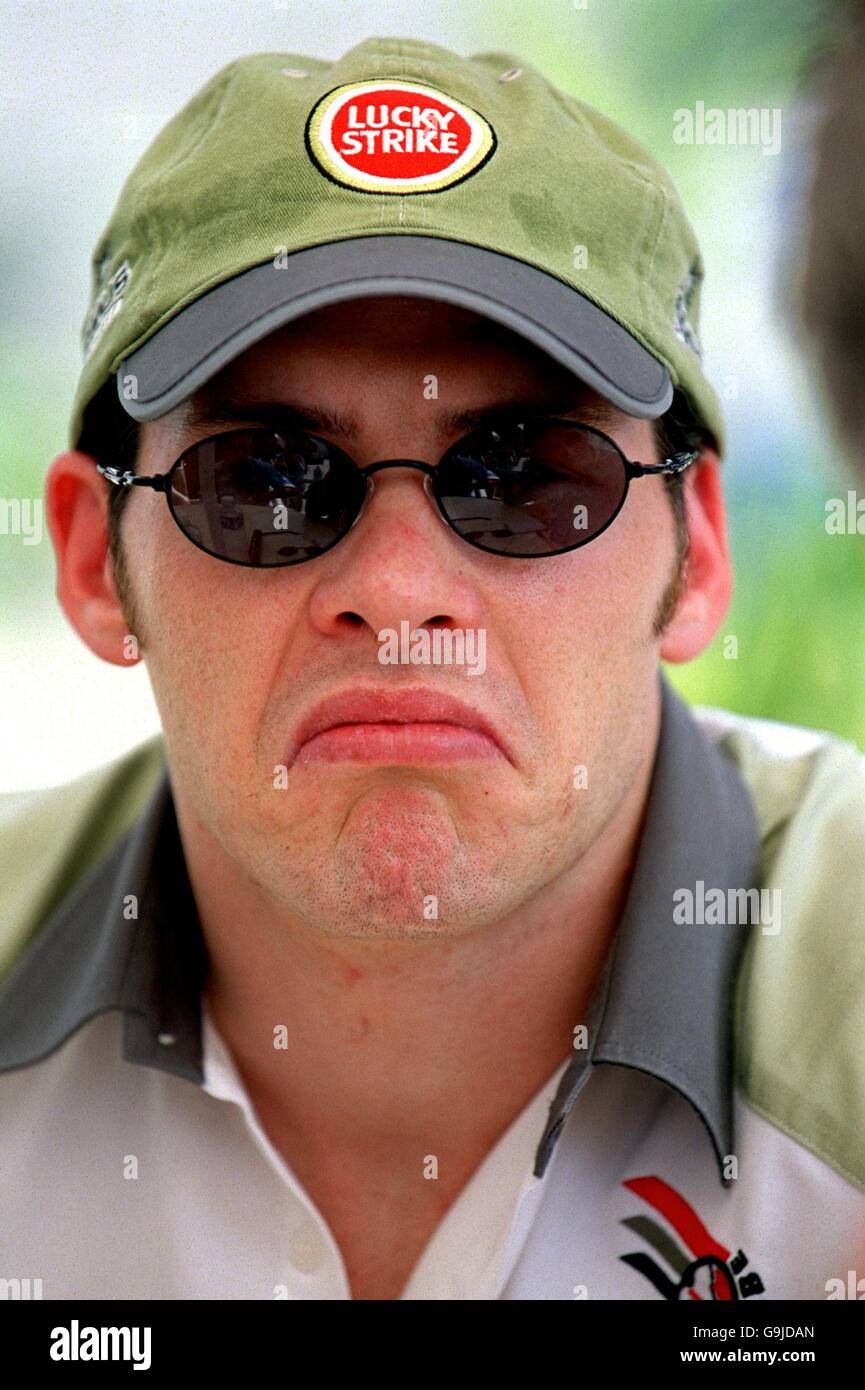 Jacques Villeneuve relives his huge Melbourne crash as he chats to jounalists in the paddock in Malayasia Stock Photo