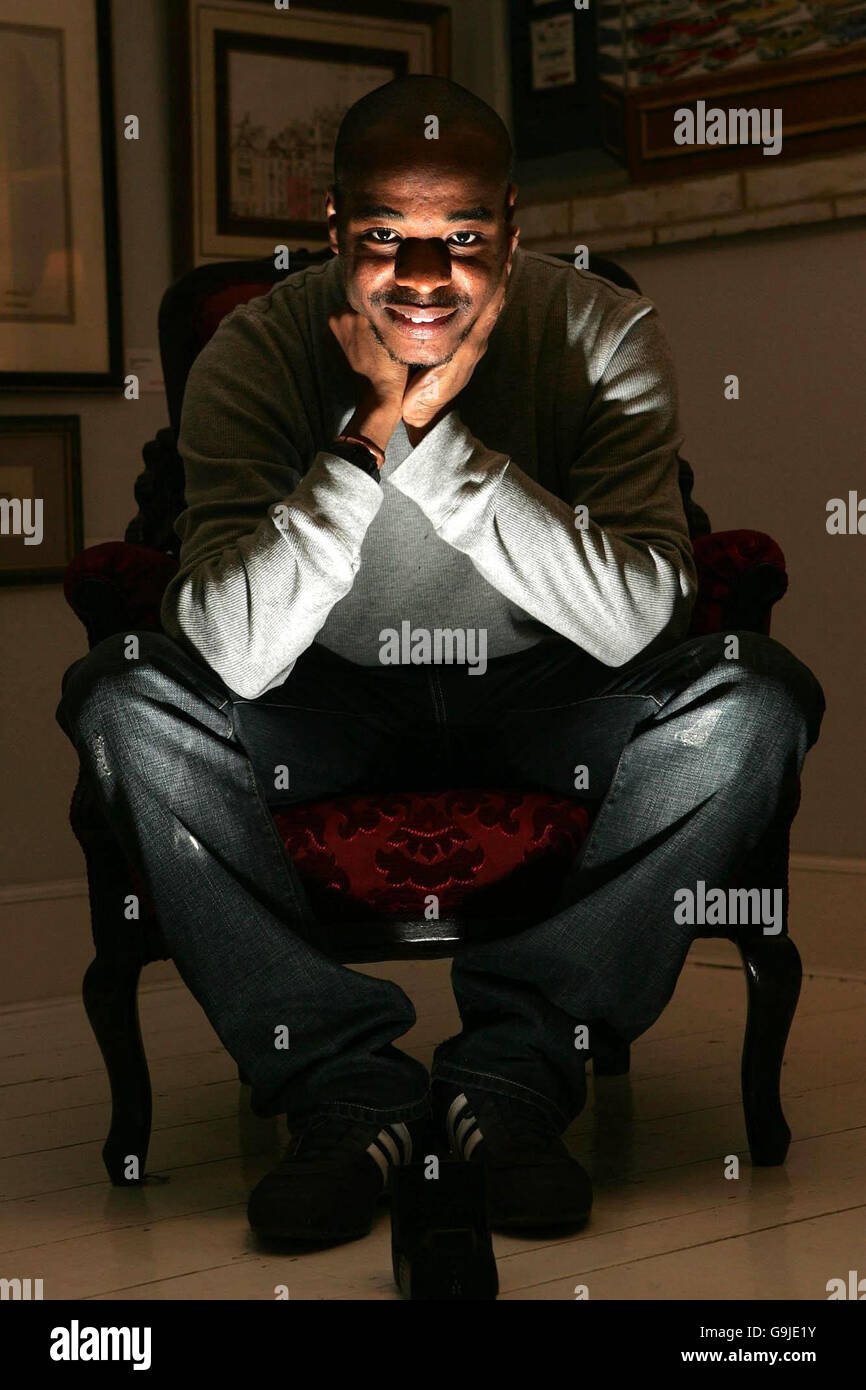 Autistic artist Stephen Wiltshire sits among a selection of his work at his gallery in Pall Mall, London. Stock Photo