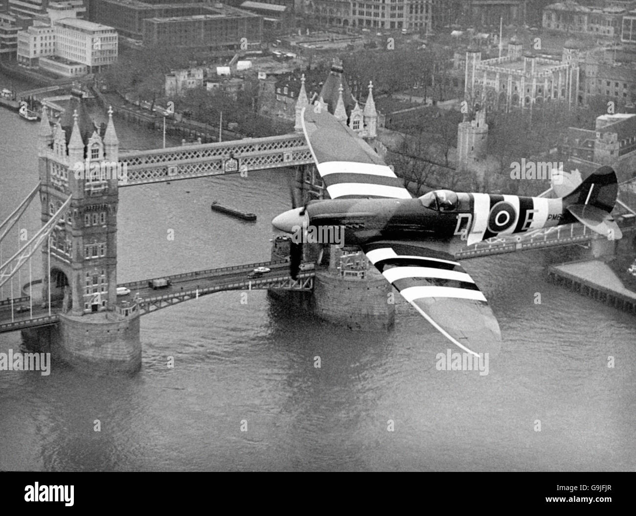 Spitfire flies over Tower Bridge Stock Photo