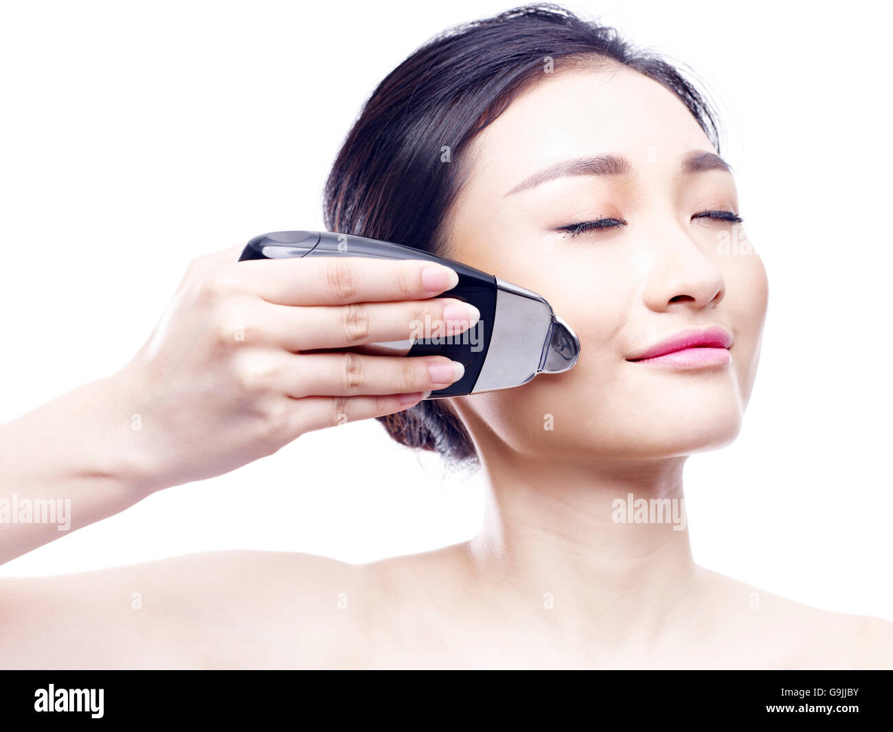 young asian woman using a face spa instrument, isolated on white Stock Photo Alamy