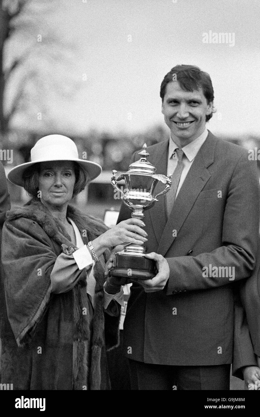 Richard Burridge, receiving the trophy from Lady Mary Meaney, wife of Sir Patrick Meaney, chairman of the Rank Organisation, after his horse Desert Orchid won the King George VI Chase at Kempton Park. Stock Photo