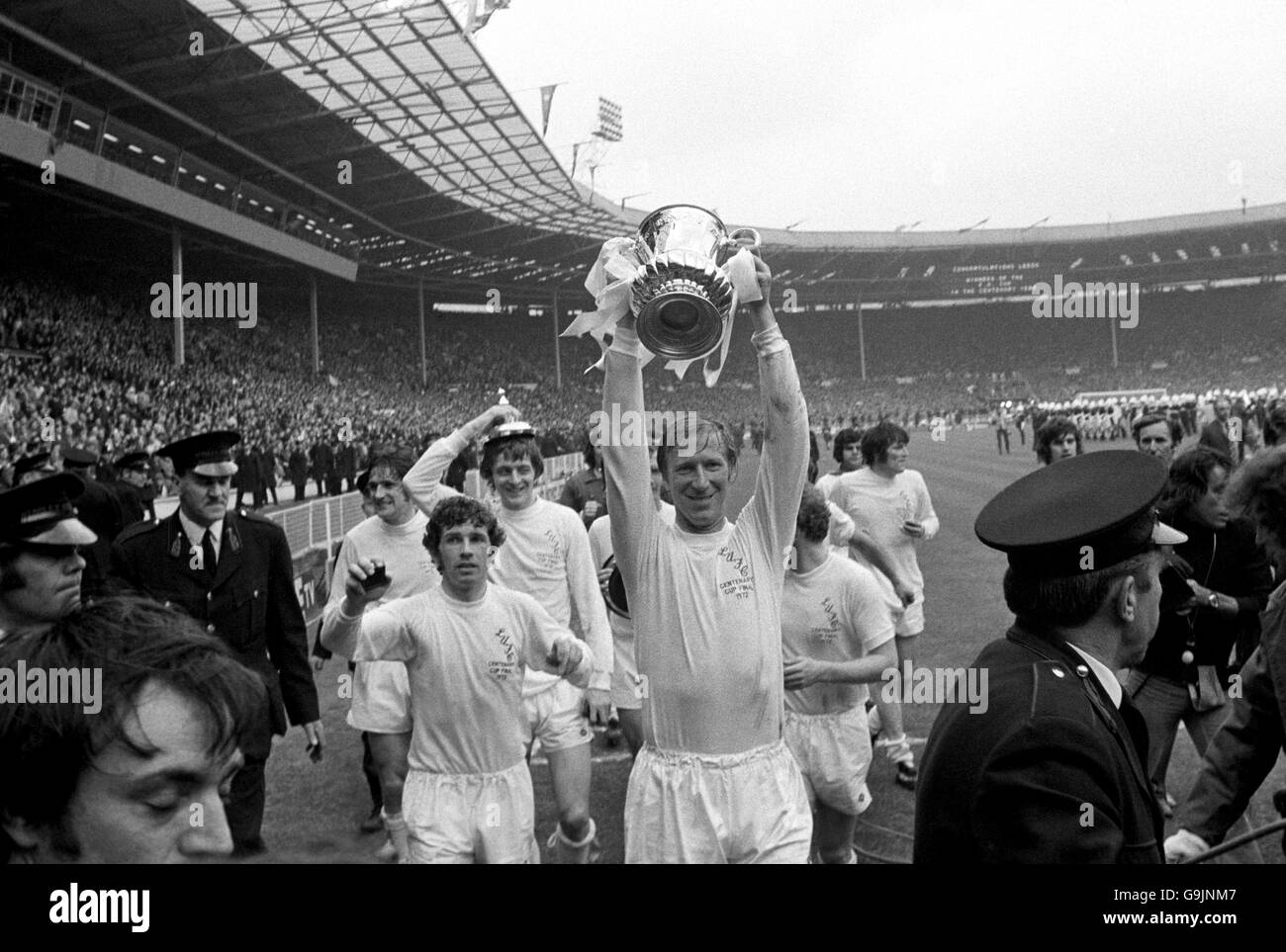 Leeds United's Jack Charlton (lifting FA Cup) makes sure he features in the next day's newspapers by posing with the FA Cup during his team's lap of honour Stock Photo