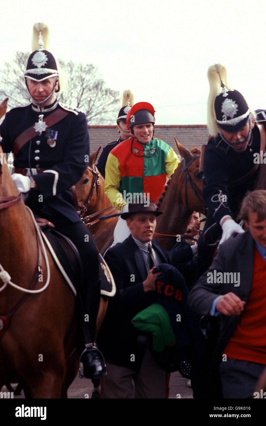 Horse Racing - The Grand National. Mr Frisk, ridden by Marcus Armytage, is escorted back to the paddock after winning the Grand National Stock Photo