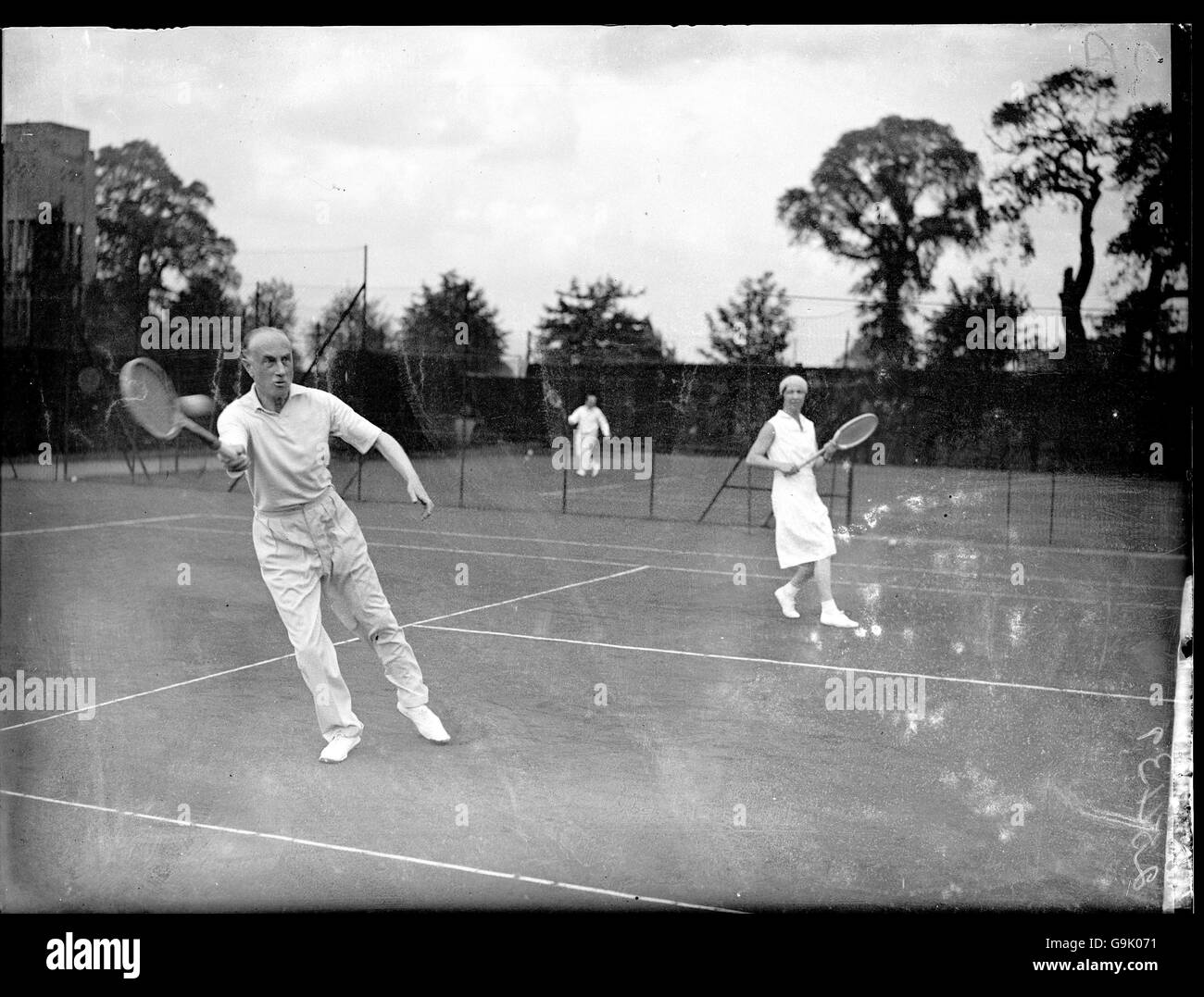 Sir Samuel Hoare (l), the Secretary for India, who is succeeding Lord D'Abernon as President of the Lawn Tennis Association, visited Wimbledon where he was able to engage in some practice on the courts Stock Photo