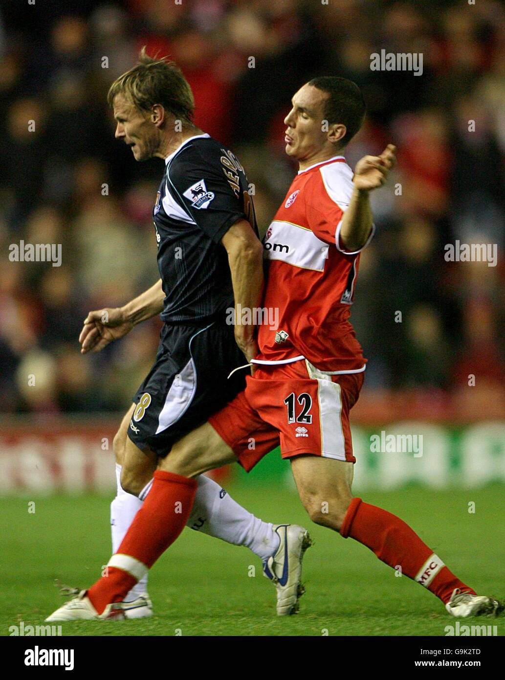 Soccer - FA Barclays Premiership - Middlesbrough v West Ham United - The Riverside. West Ham United's Teddy Sheringham is tackled by Middlesbrough's Stewart Downing Stock Photo