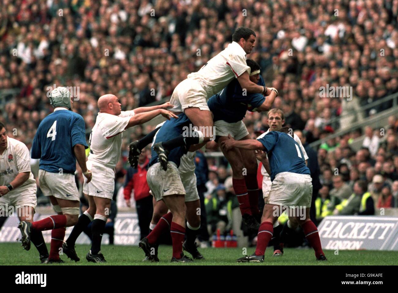 England's Martin Johnson (l) jumps for the ball with France's Abdelatif Benazzi (r) Stock Photo
