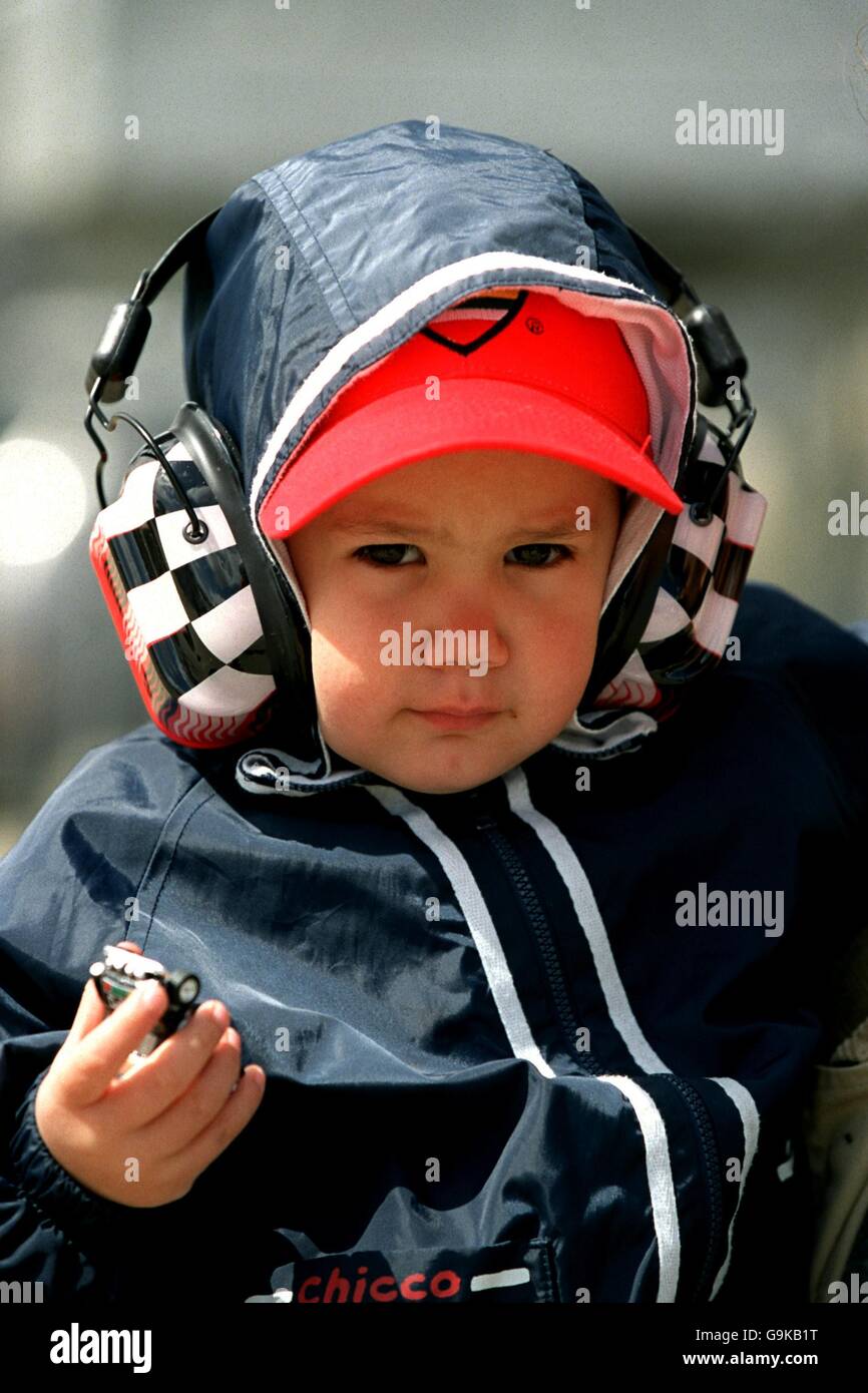 Formula One Motor Racing - San Marino Grand Prix - Qualifying. A young Formula One fan with chequered flag earmuffs Stock Photo