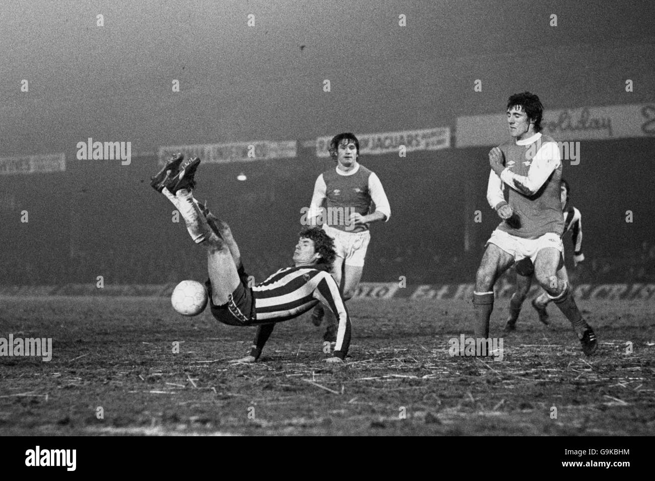 (L-R) Sheffield Wednesday's Ray Blackhall fails to make contact with a spectacular scissors kick attempt as Arsenal's Pat Rice and Frank Stapleton look on Stock Photo