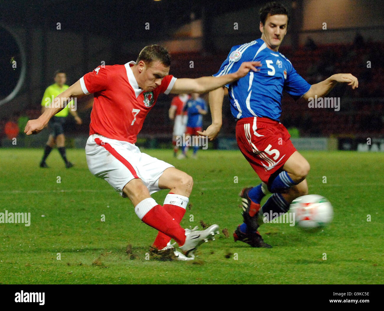 Wales' Craig Bellamy (left) passes the ball as Liechtenstein's Christof Ritter attempts to intercept during a Friendly International at the Racecourse Ground, Wrexham. Stock Photo