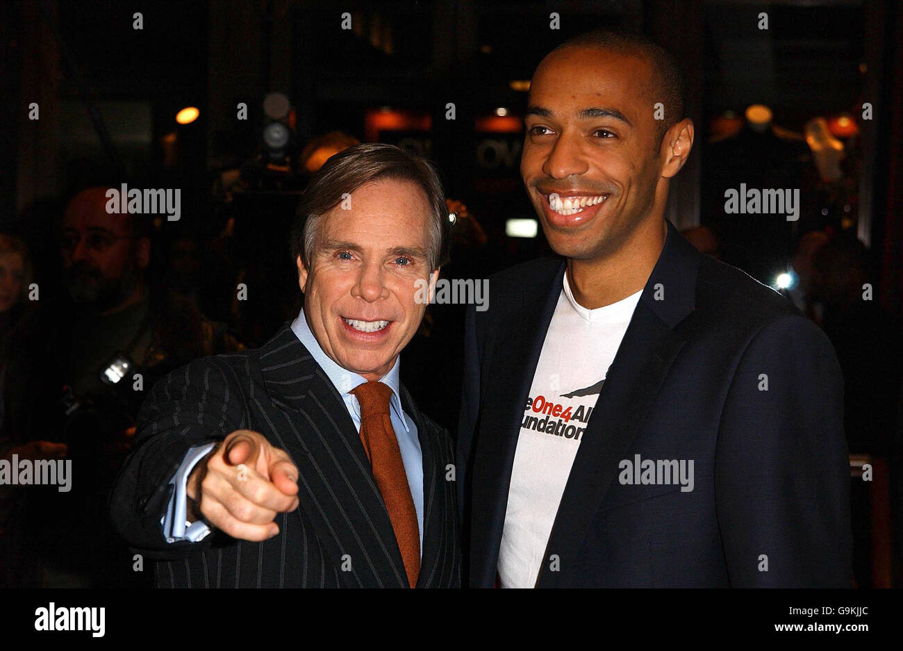 France & Arsenal footballer Thierry Henry (right) & designer Tommy Hilfiger  at a photocall to announce an exciting new partnership, in the Hilfiger  Store in Regent Street, central London Stock Photo -