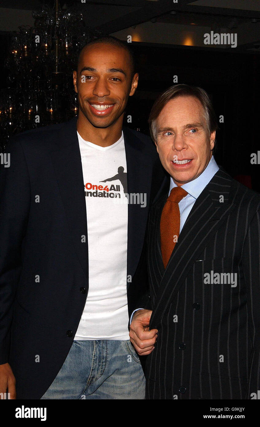 France & Arsenal footballer Thierry Henry (left) & designer Tommy Hilfiger  at a photocall to announce an exciting new partnership, in the Hilfiger  Store in Regent Street, central London Stock Photo -