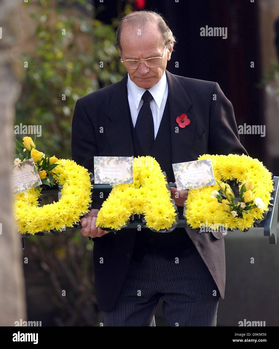 A wreath is carried for the funeral service of dead trawlerman Edward