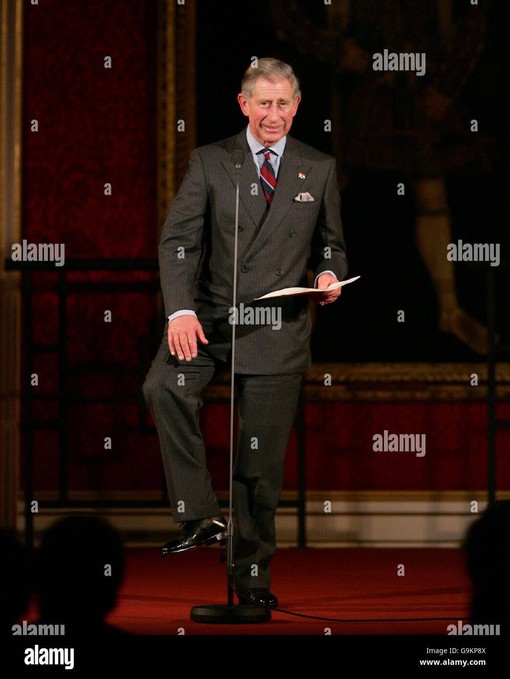 Britain's Prince Charles, the Prince of Wales, slaps his leg as he speaks, in reference to Hungarian national dancing, during a concert to commemorate the 50th anniversary of the 1956 Hungarian Revolution at London's St. James's Palace. Stock Photo