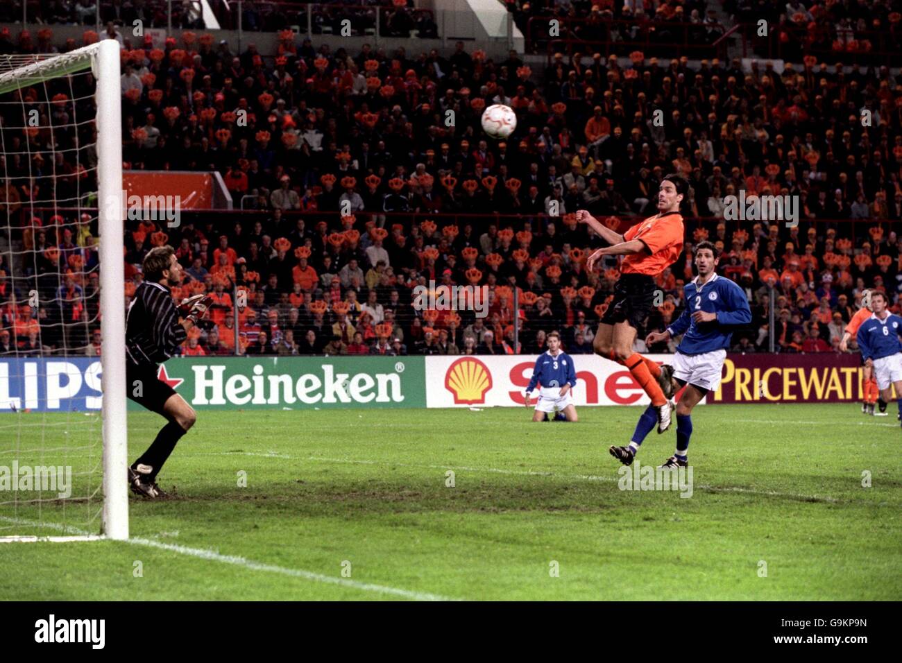 Holland's Ruud Van Nistelrooy scores Holland's fourth goal against Cyprus after being left unmarked by Petros Konnafis (R) Stock Photo