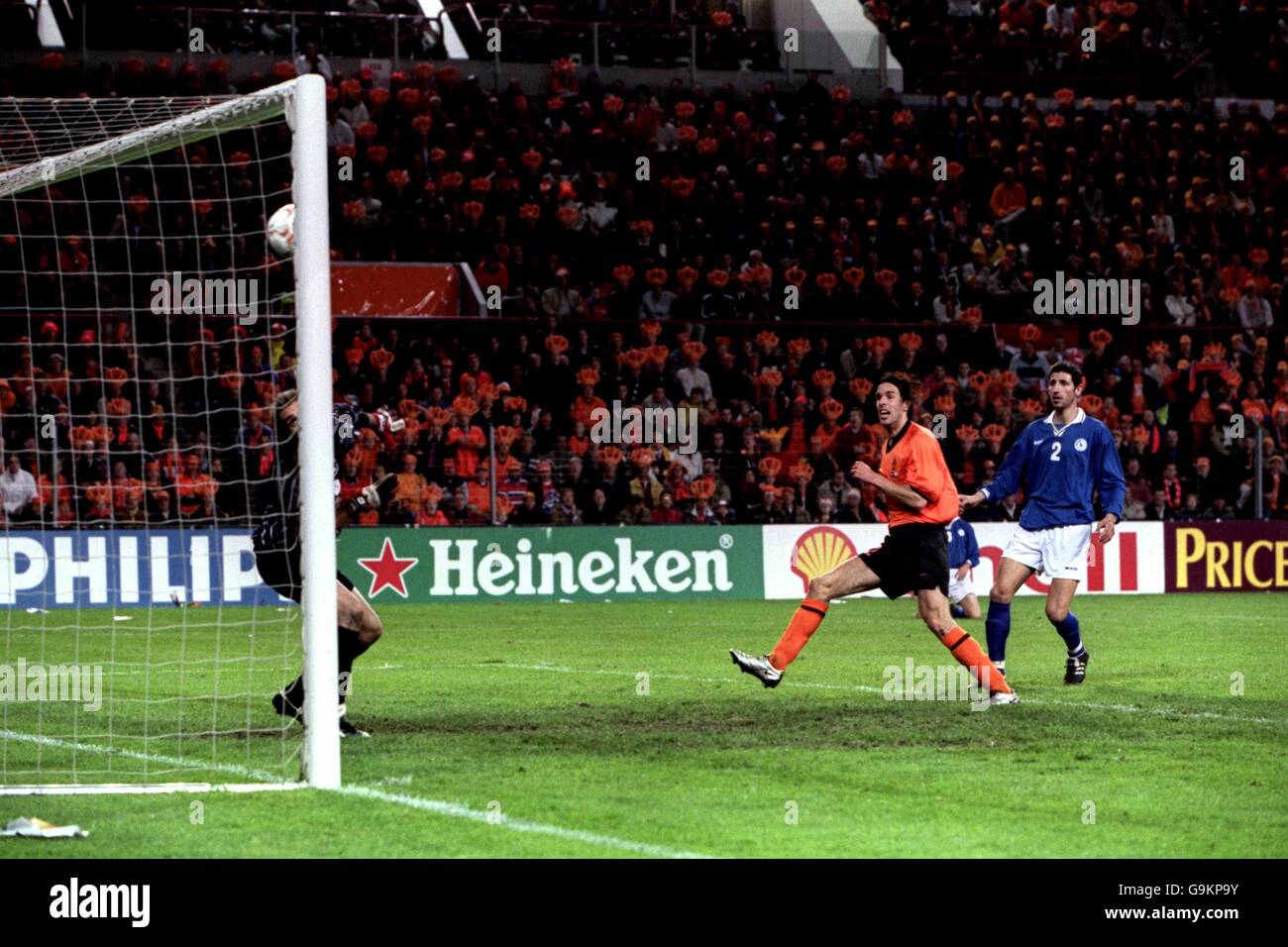 Holland's Ruud van Nistelrooy scores Holland's fourth goal against Cyprus after being left unmarked by Petros Konnafis as goalkeeper Michael Morphis looks on. Stock Photo