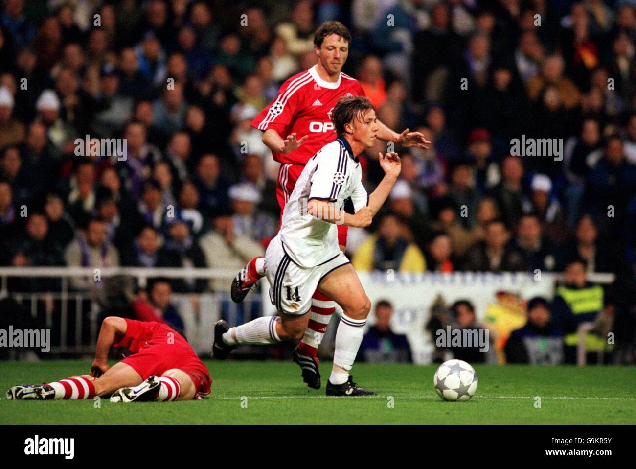 Soccer - UEFA Champions League - Semi Final First Leg - Real Madrid v Bayern Munich. Real Madrid's Guti (r) leaves Bayern Munich's Willy Sagnol (l) in a heap on the floor Stock Photo