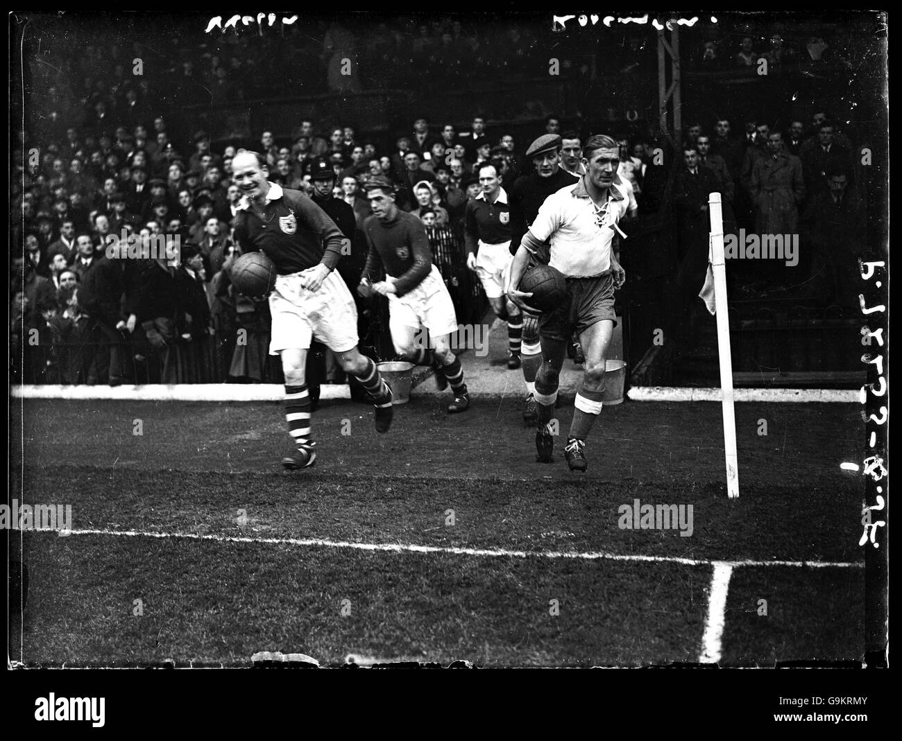 Charlton Athletic captain Don Welsh (l), and Norrkoping captain B Rosengren (r), lead their teams out before the match Stock Photo