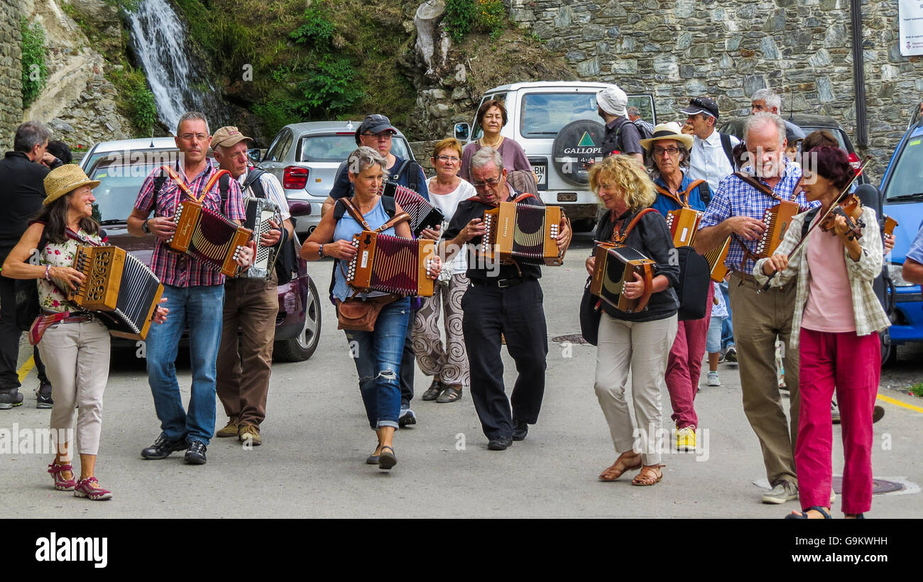 A group of accordion musicians walking and performing in the street of a small village Stock
